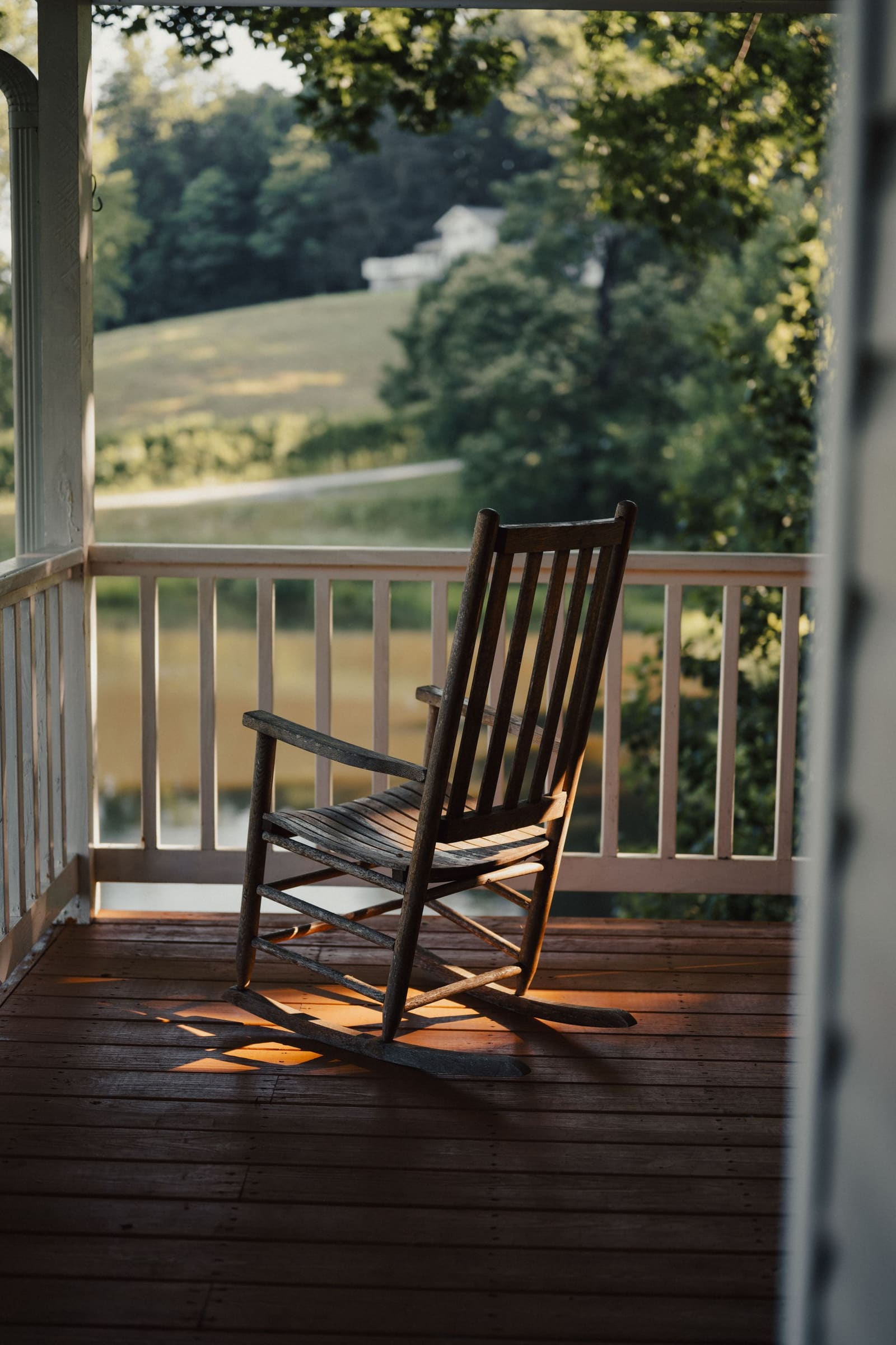 A rocking chair on the front porch of the Avian Care house in the afternoon sun
